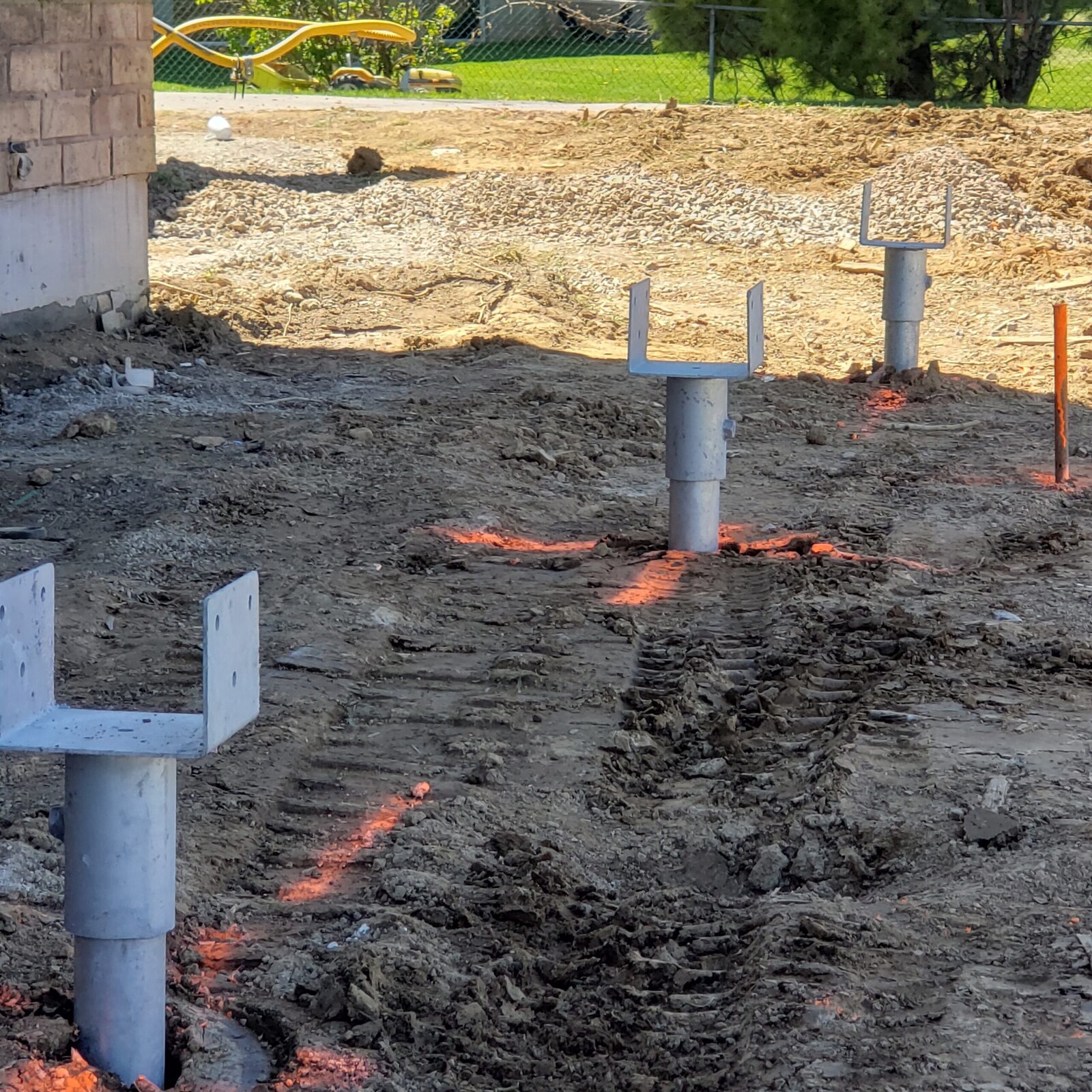 Installed helical piles prepared with structural brackets