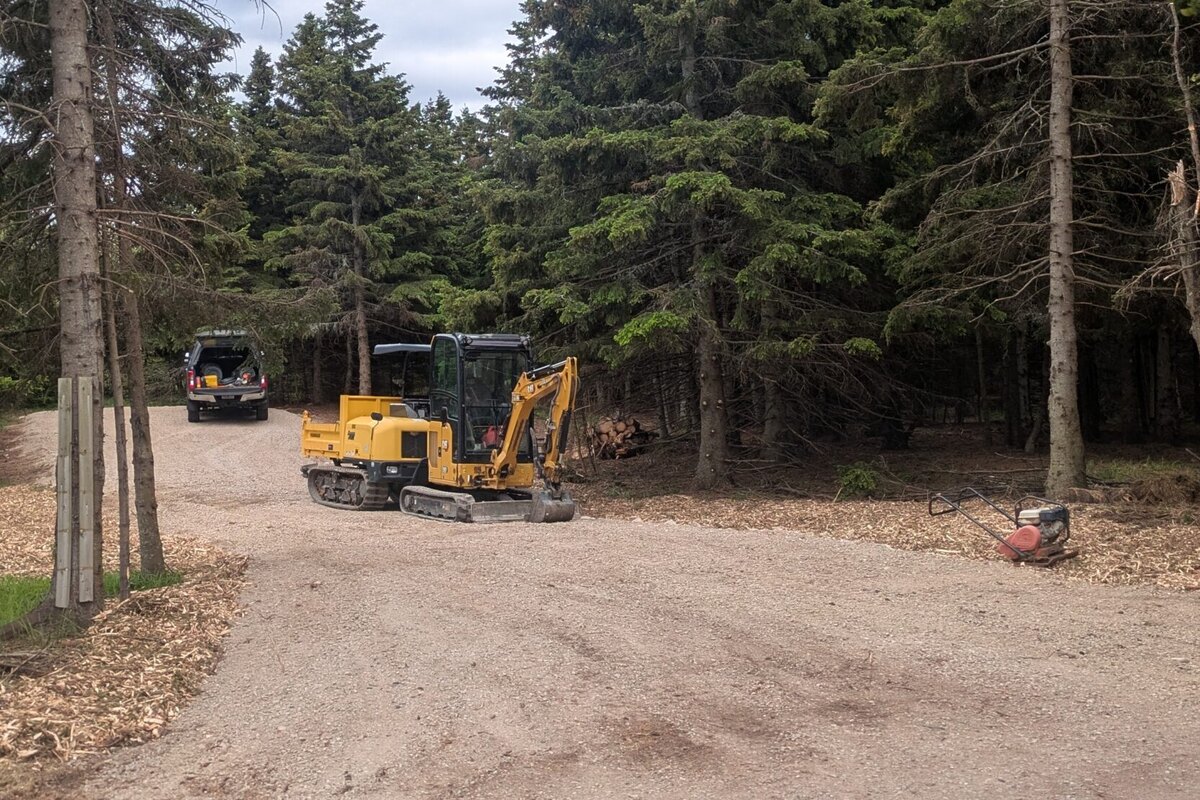 Completed driveway and landscape work on a wooded Cape Breton property