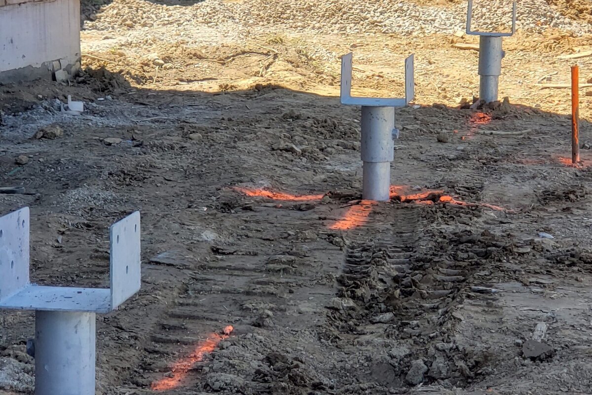 Installed helical piles with structural brackets